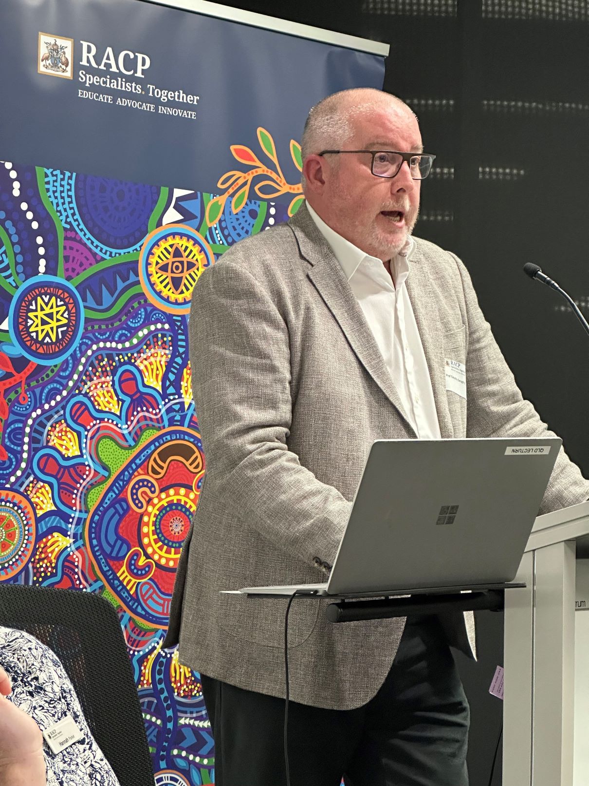 Tim Geraghty standing behind a lectern.