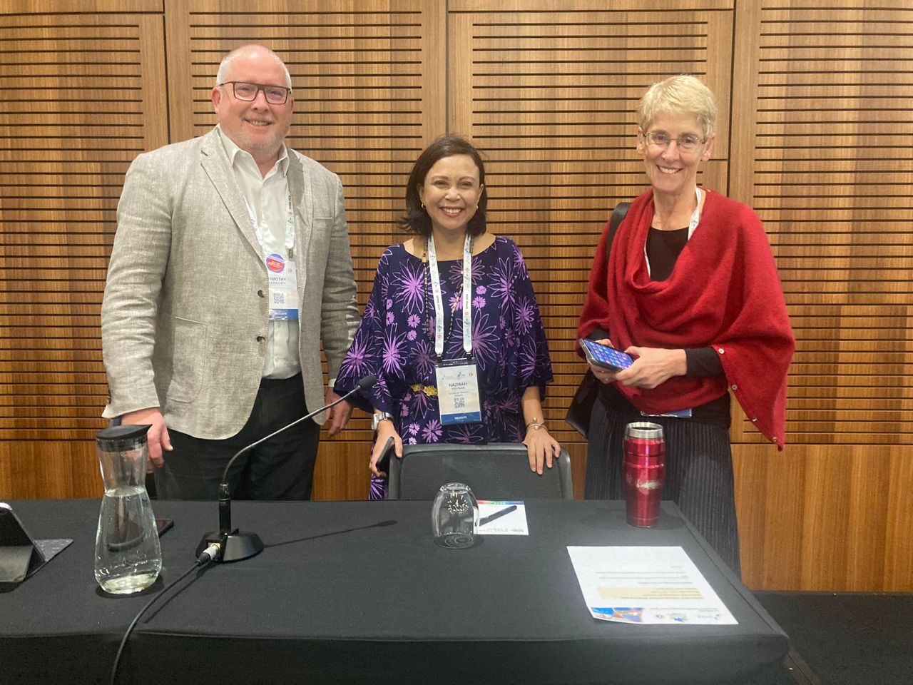 Prof Tim Geraghty standing with Prof Nasirah Hasnan from Malaysia and Prof Lisa Harvey from Sydney who were two other speakers in the session